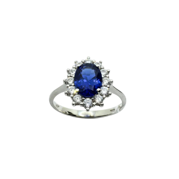 Anello Royal Ring in Oro Bianco 18 KT con Zircone Blu Taglio Ovale e Contorno di Zirconi Bianchi AN051
